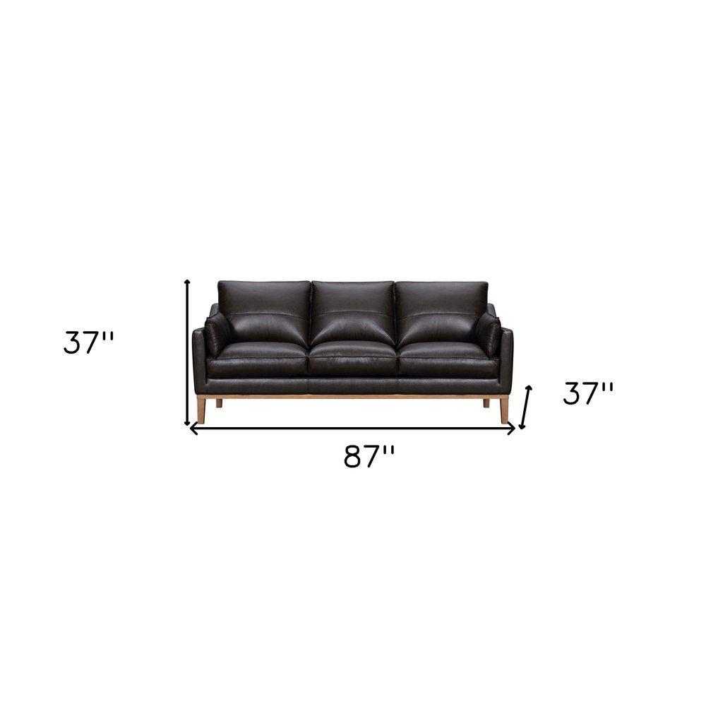 87" Gray Leather Sofa And Toss Pillows With Brown Legs