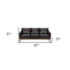 87" Gray Leather Sofa And Toss Pillows With Brown Legs
