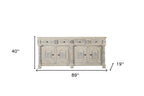 89" White Distressed Solid Wood Carved Scrollwork Four Drawer Sideboard With Four Doors